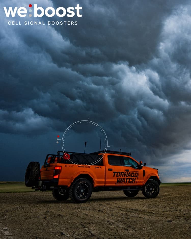 Pickup truck on a farm with clouds in the background